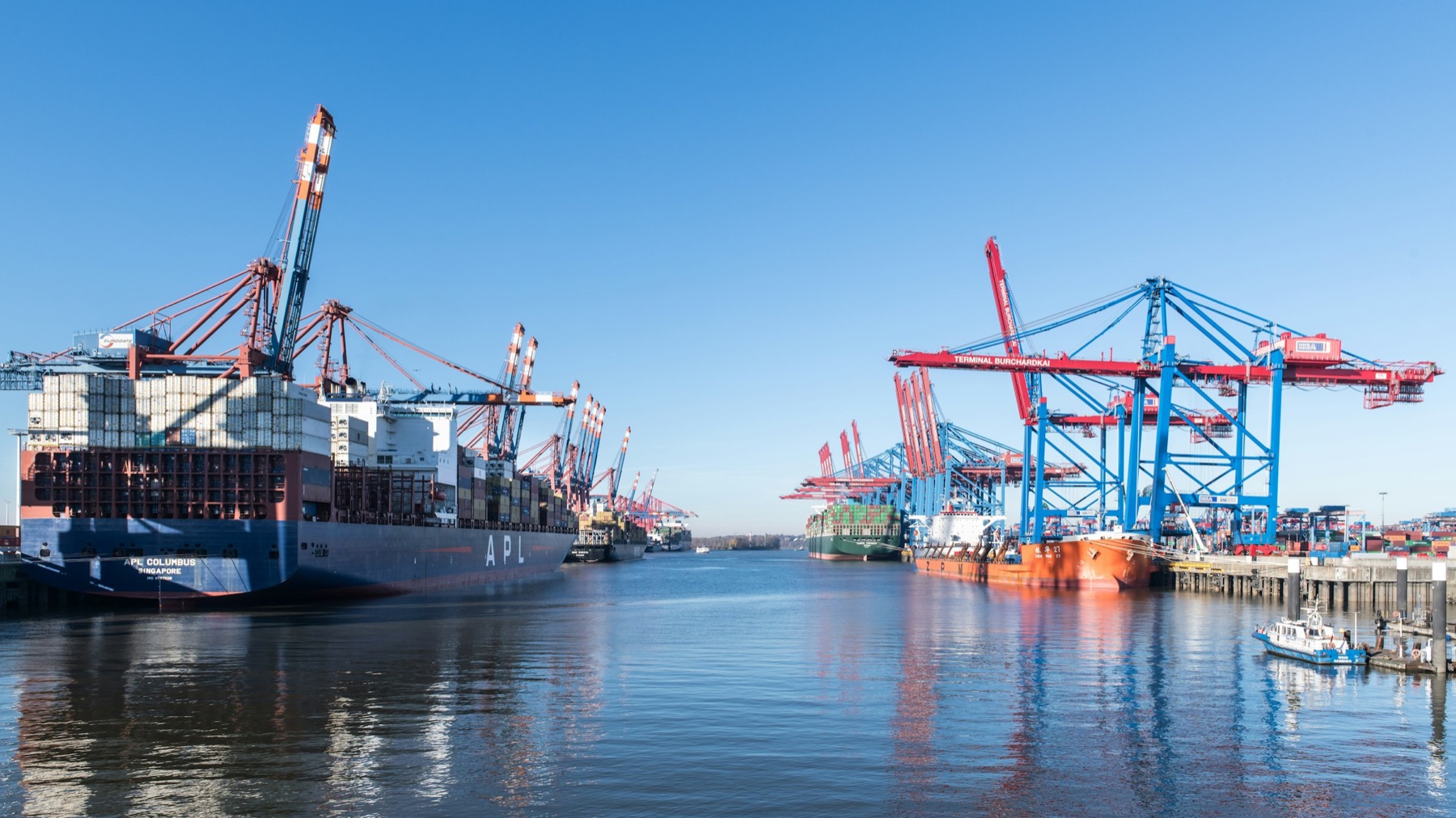Container vessels and cranes at a busy commercial port