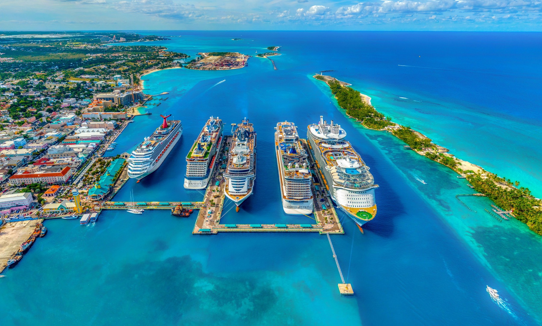 Aerial view of cruise and passenger vessels alongside a port terminal