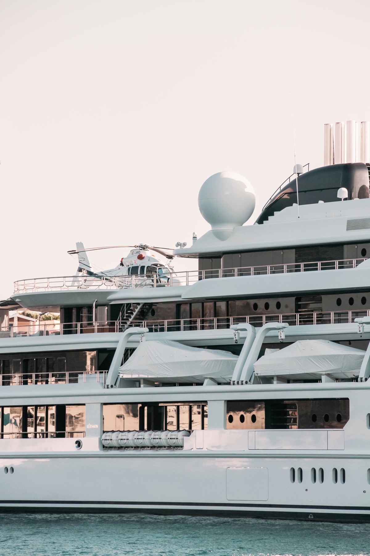Large yacht deck and equipment detail with tender and helipad area