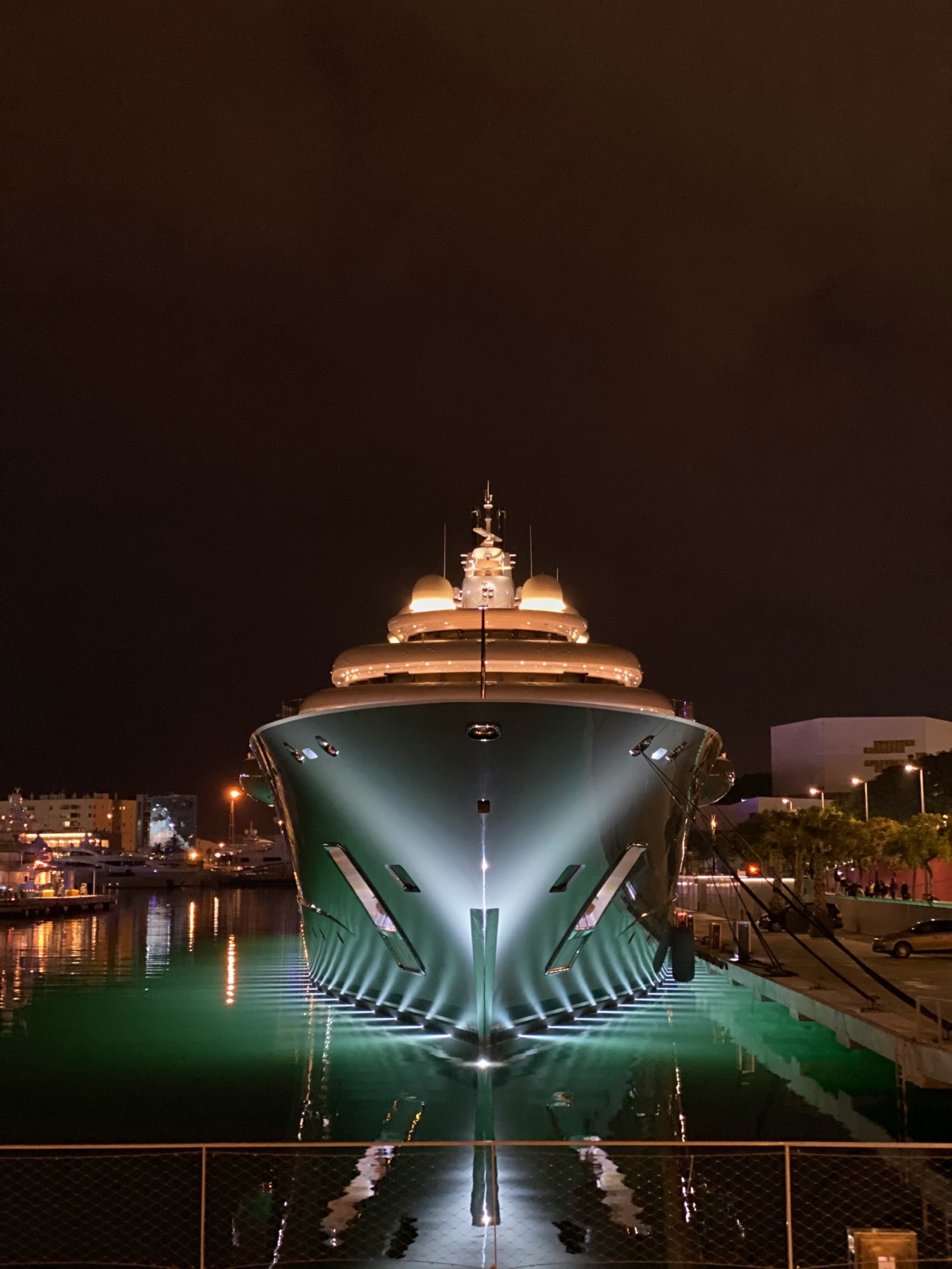 Large yacht bow at night alongside a harbour berth