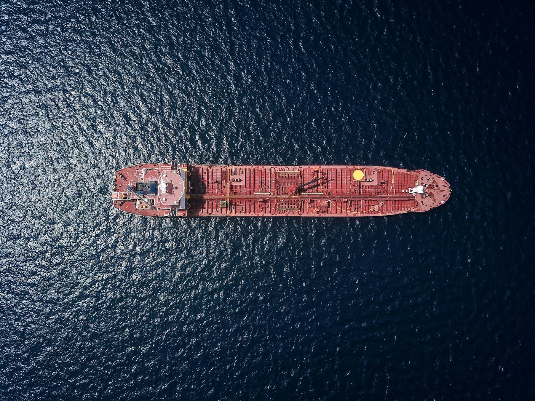 Aerial view of a red tanker underway at sea